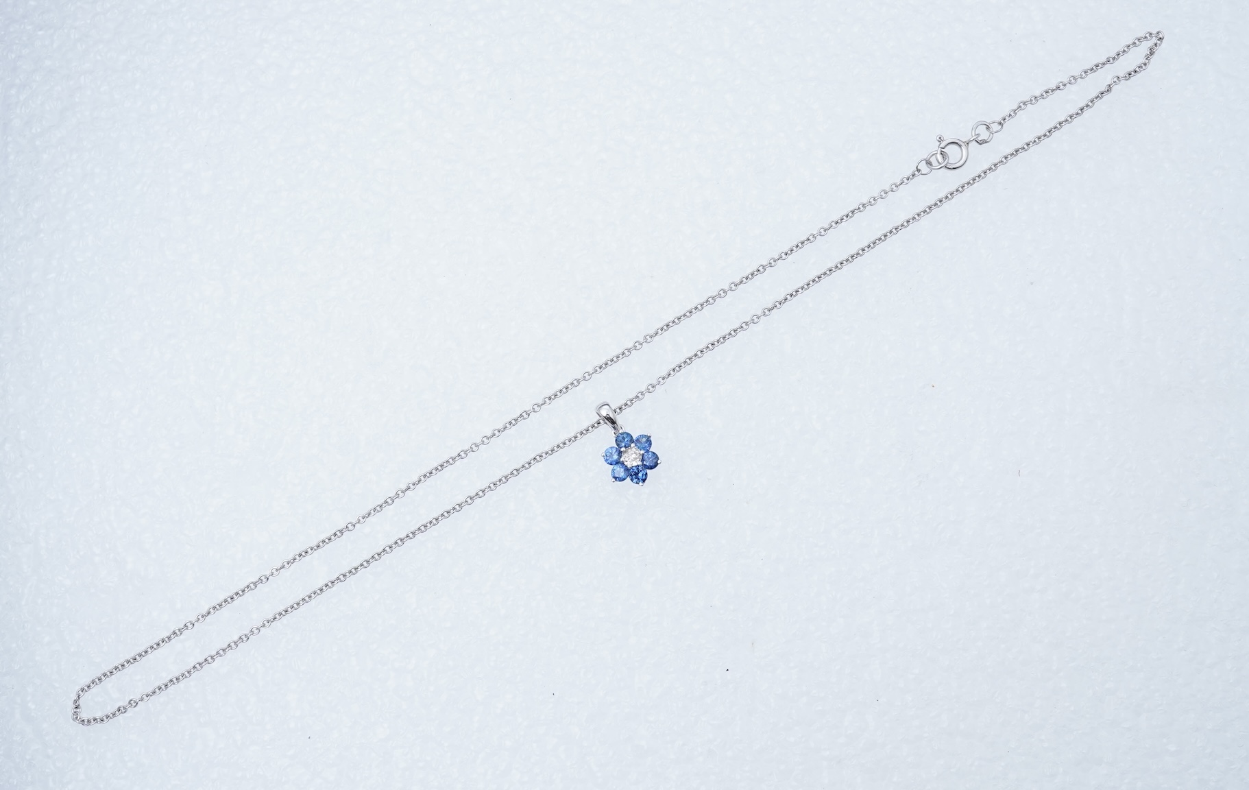 A sapphire and diamond pendant